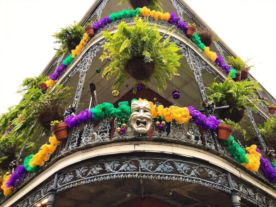 Mardi Gras Corner of the decorated building with a face mask