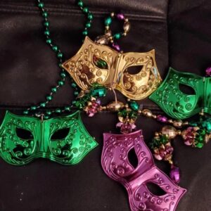 Four masks on Mardi Gras beads