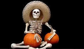 a skeleton with a hat and two pumpkins
